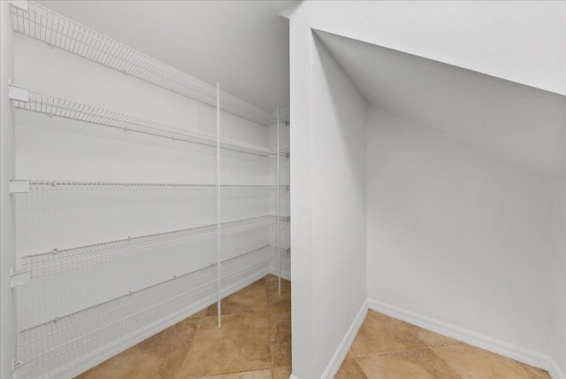 spacious closet featuring light tile patterned floors