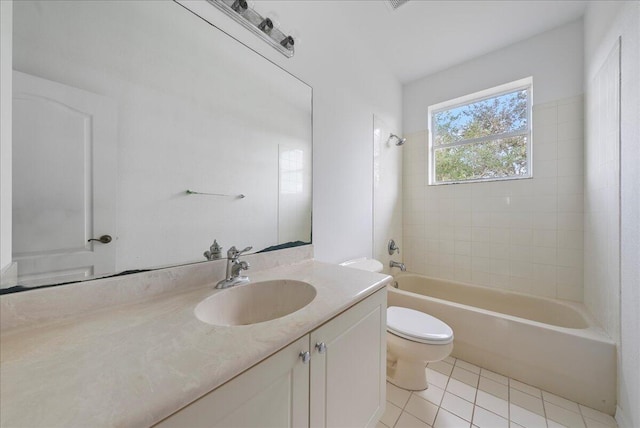 full bathroom with tile patterned flooring, tiled shower / bath combo, toilet, and vanity