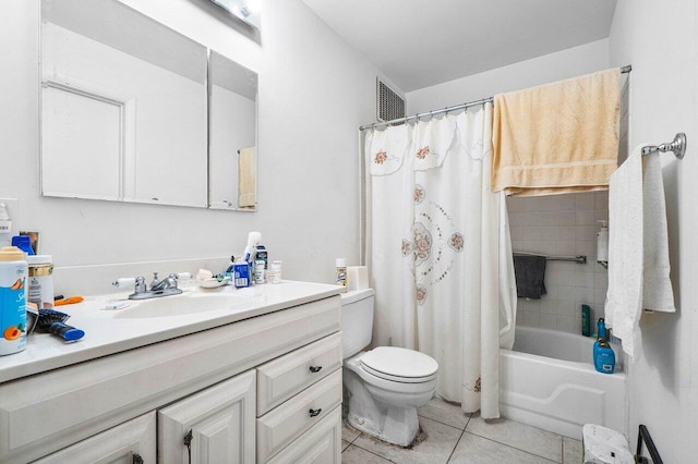 full bathroom featuring shower / bath combo with shower curtain, tile patterned floors, vanity, and toilet