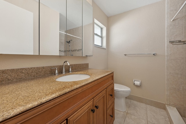 bathroom with tile patterned flooring, vanity, toilet, and tiled shower