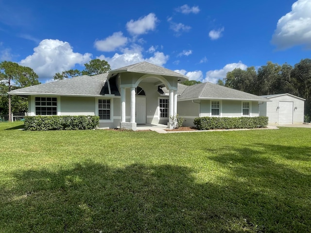 view of front of home with a storage unit and a front lawn