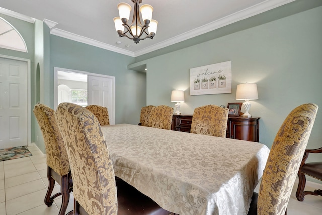 tiled dining area featuring a notable chandelier and crown molding