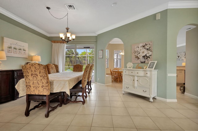 tiled dining space with ornamental molding and an inviting chandelier