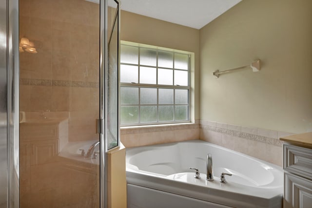 bathroom with vanity and independent shower and bath