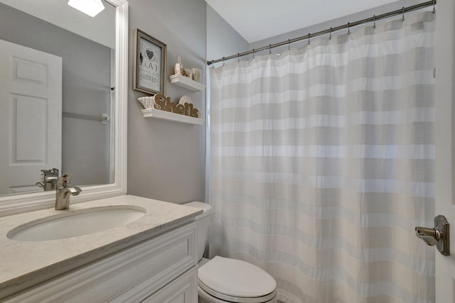 bathroom featuring curtained shower, vanity, and toilet