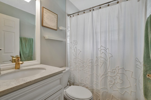 bathroom featuring vanity, toilet, and a shower with shower curtain