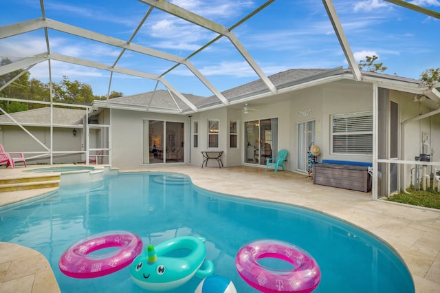 view of pool featuring a lanai, an in ground hot tub, ceiling fan, and a patio