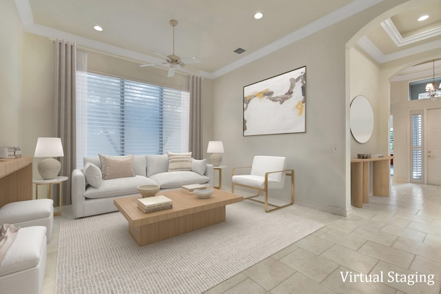 living room with ceiling fan with notable chandelier, ornamental molding, and light tile patterned floors