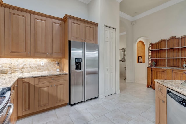 kitchen with light stone countertops, stainless steel appliances, tasteful backsplash, light tile patterned floors, and ornamental molding