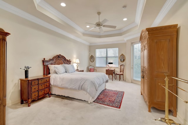 bedroom featuring a raised ceiling, ceiling fan, light carpet, and ornamental molding