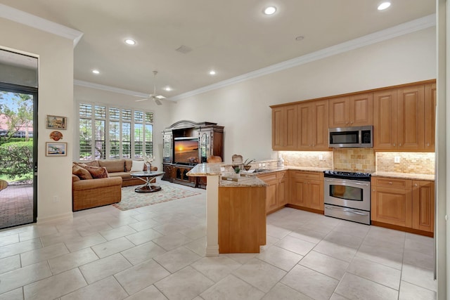 kitchen featuring tasteful backsplash, kitchen peninsula, ornamental molding, and appliances with stainless steel finishes