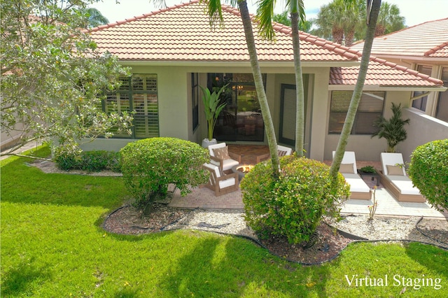 back of house with stucco siding, a patio, and a lawn