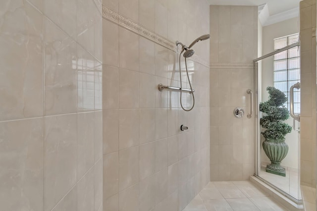 bathroom with a tile shower and crown molding