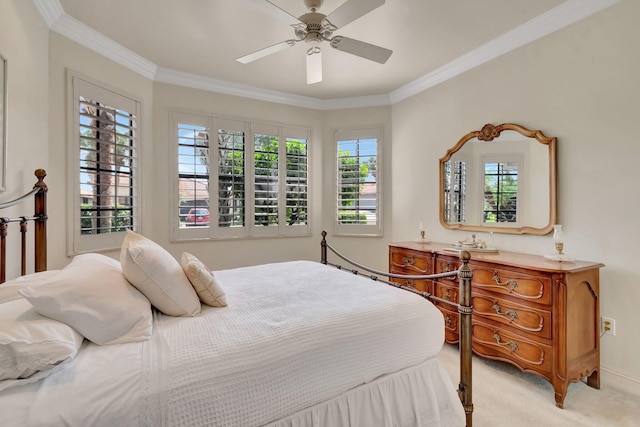 bedroom with light colored carpet, ceiling fan, and crown molding