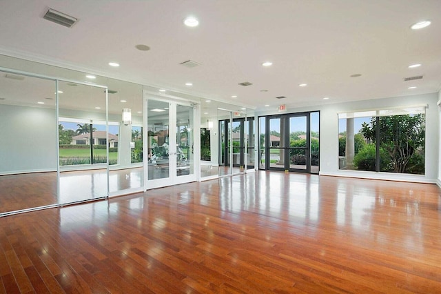 interior space featuring french doors, hardwood / wood-style flooring, and expansive windows