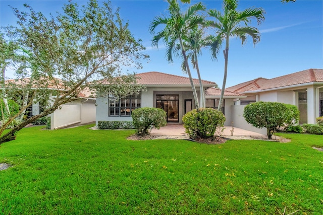 rear view of property with a yard