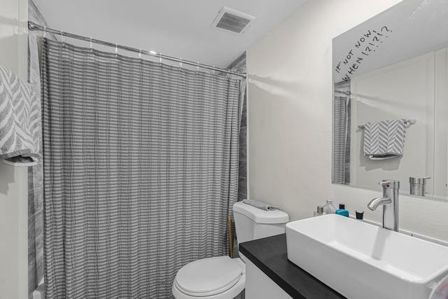 bathroom featuring vanity, a shower with shower curtain, and toilet