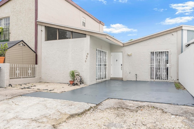 rear view of property featuring a patio area