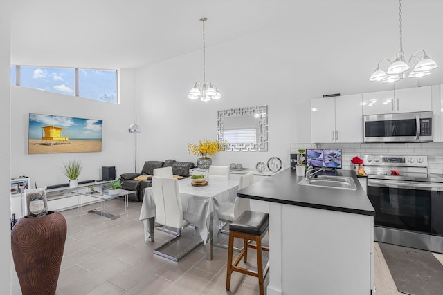 dining space with sink and a high ceiling