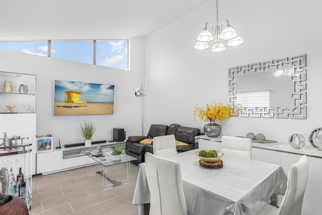 dining space with an inviting chandelier and high vaulted ceiling