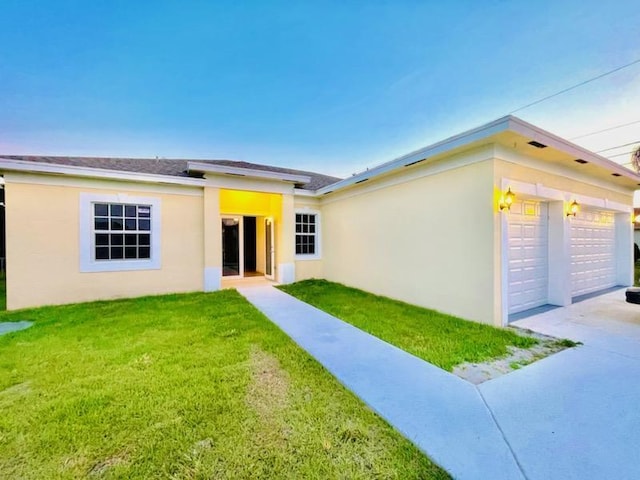 view of front of home featuring a garage and a front lawn