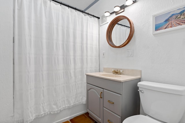 full bathroom featuring vanity, shower / tub combo, and toilet