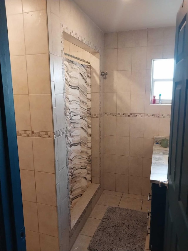 bathroom featuring tile patterned floors, tile walls, vanity, and a shower with shower curtain