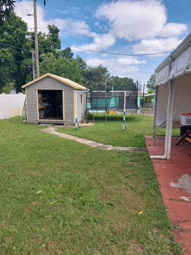 view of yard with a storage unit, a patio, and a trampoline