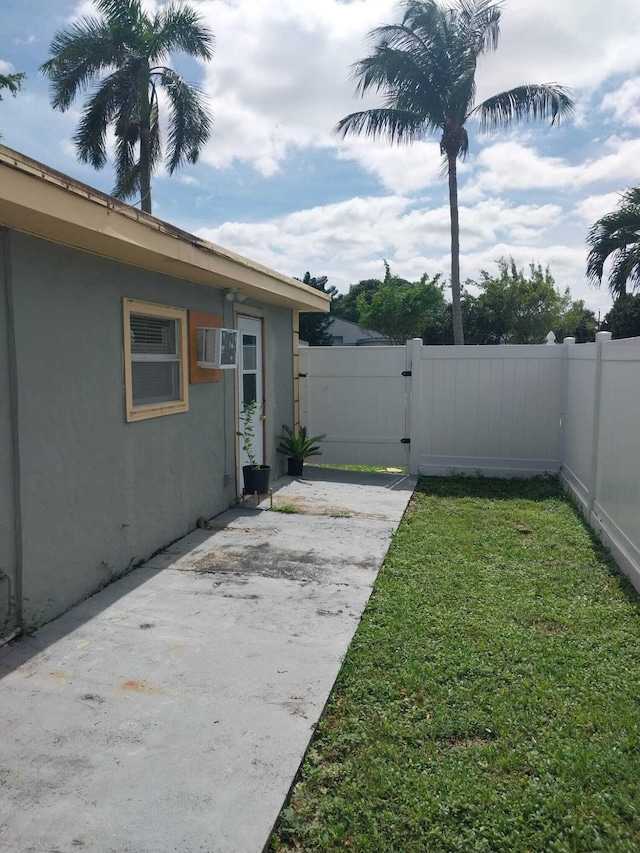 view of yard with a patio and a wall mounted AC