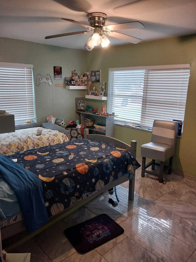 tiled bedroom featuring ceiling fan