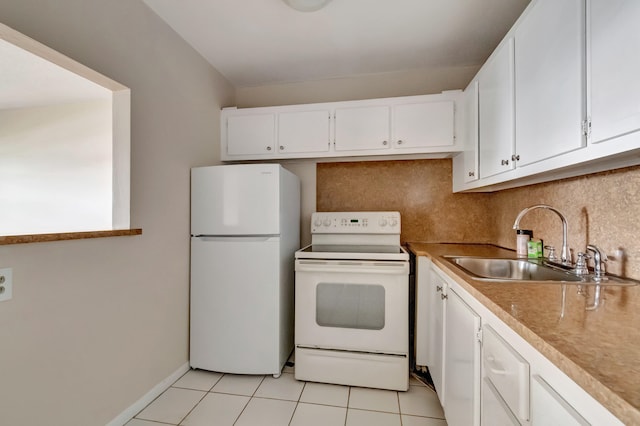 kitchen with light tile patterned floors, white cabinets, sink, and white appliances