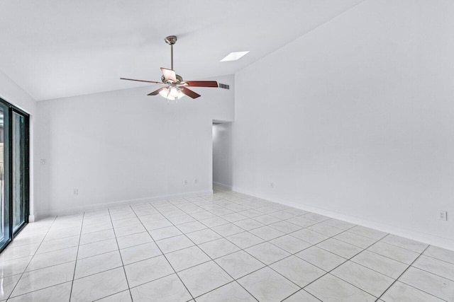 spare room with lofted ceiling with skylight and ceiling fan