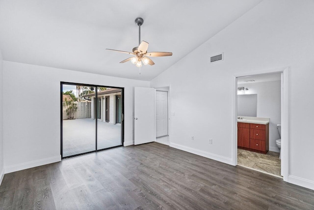 unfurnished bedroom with connected bathroom, dark hardwood / wood-style flooring, high vaulted ceiling, and access to exterior