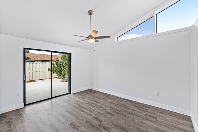 spare room with ceiling fan, lofted ceiling, and wood-type flooring