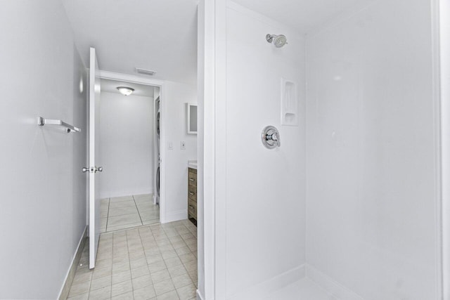 bathroom with vanity, a shower, and tile patterned floors