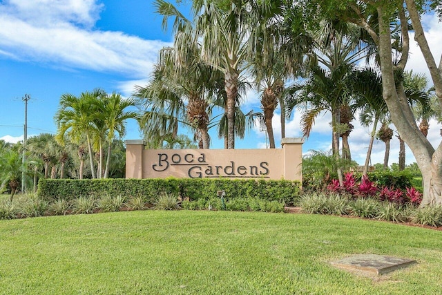 community / neighborhood sign with a lawn