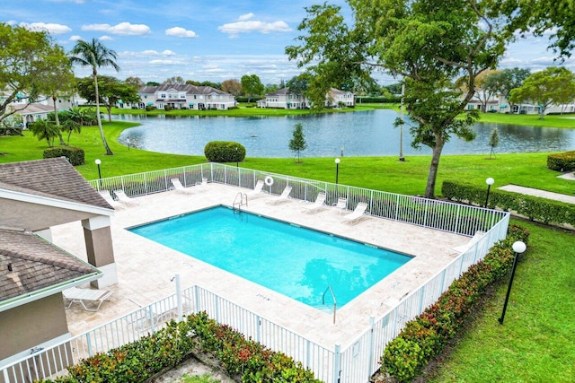 view of swimming pool with a water view, a yard, and a patio area