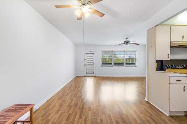 unfurnished living room with light wood-type flooring, ceiling fan, and a textured ceiling