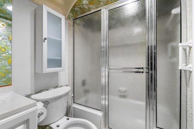 full bathroom featuring shower / bath combination with glass door, vanity, and toilet