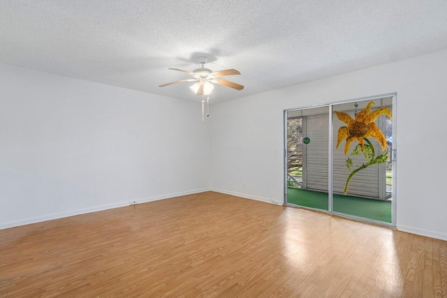 empty room with ceiling fan, light hardwood / wood-style floors, and a textured ceiling