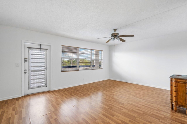 foyer entrance featuring a textured ceiling, ceiling fan, and light hardwood / wood-style flooring