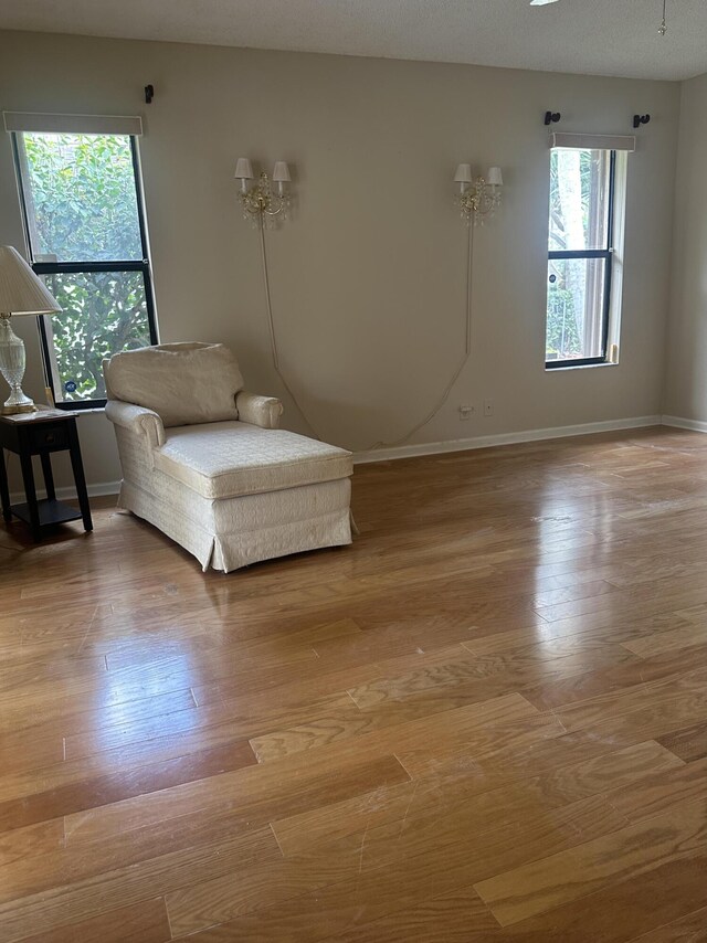 unfurnished room with hardwood / wood-style floors, ceiling fan, and a textured ceiling