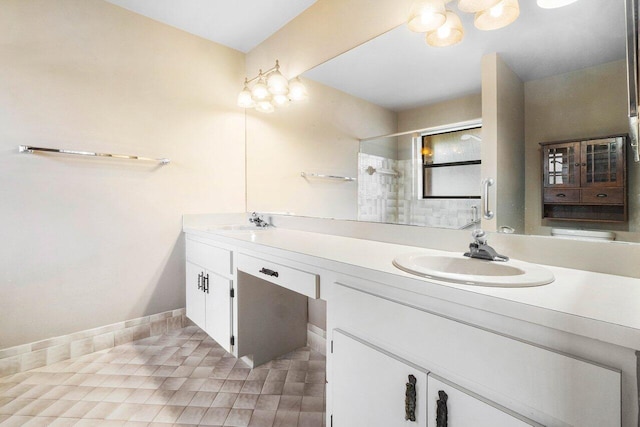 full bath with double vanity, tile patterned flooring, a tile shower, and a sink