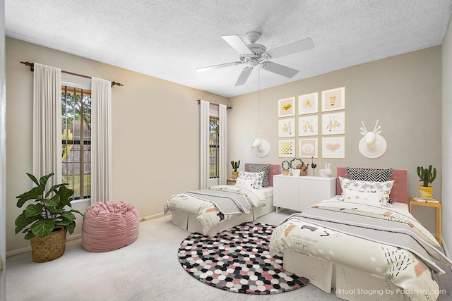 bedroom with a textured ceiling, ceiling fan, carpet flooring, and baseboards