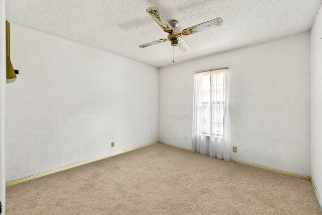 spare room with light carpet, ceiling fan, and a textured ceiling