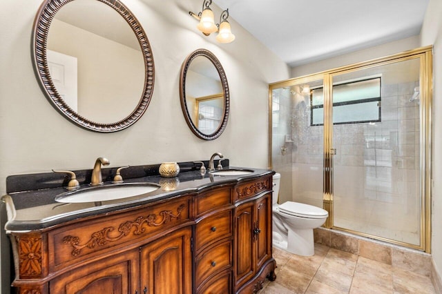 bathroom with a sink, a shower stall, toilet, and double vanity