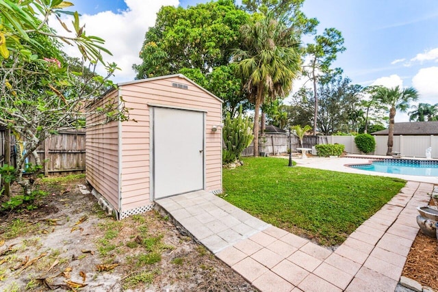 view of outbuilding with a yard and a fenced in pool