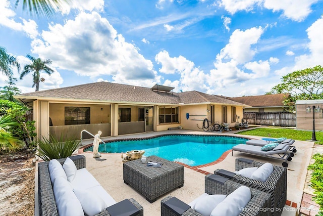 view of swimming pool featuring a patio area, fence, an outdoor living space, and a fenced in pool