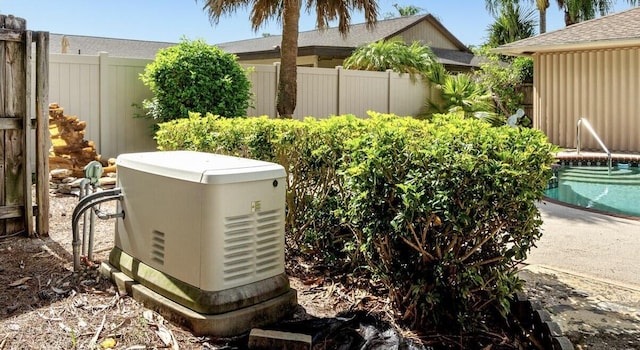 exterior details featuring fence and a power unit