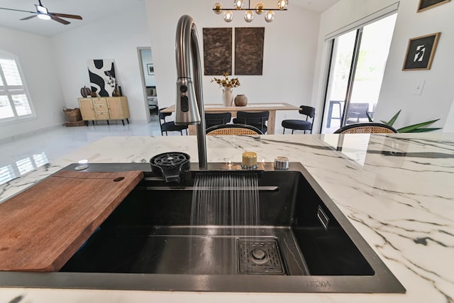 kitchen with sink and lofted ceiling